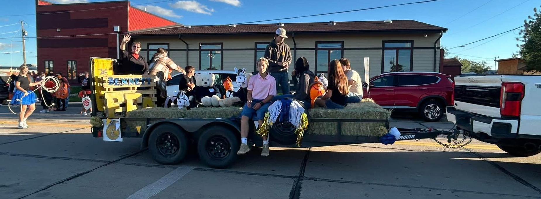 A parade float with people and animals celebrating an event.