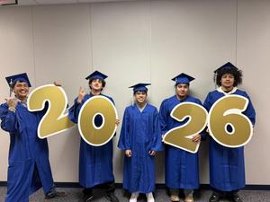 reese education center graduates celebrate with 2026 sign together