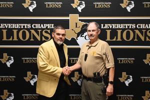 Mr. Everett and Mr. Guthrie shaking hands.