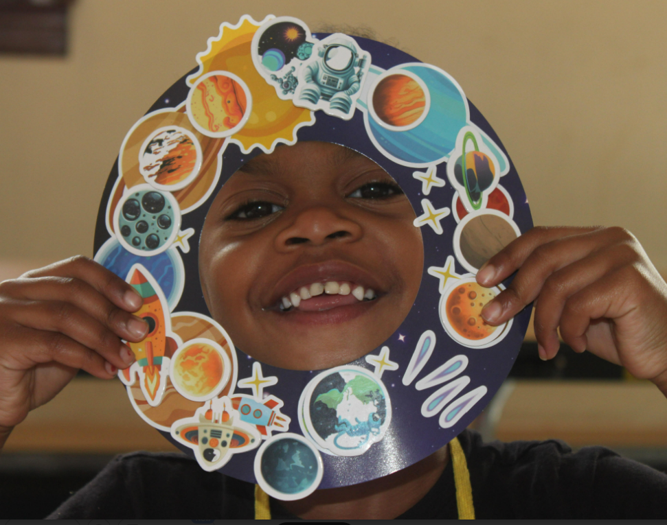 Camp NDA photo of a student with arts and craft project