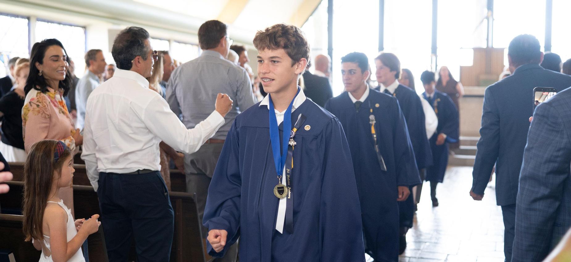 guests congratulate graduate with fist bump at the end of graduation ceremony