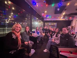 group of high schoolers seated in restaurant with state representative Marci Mustello