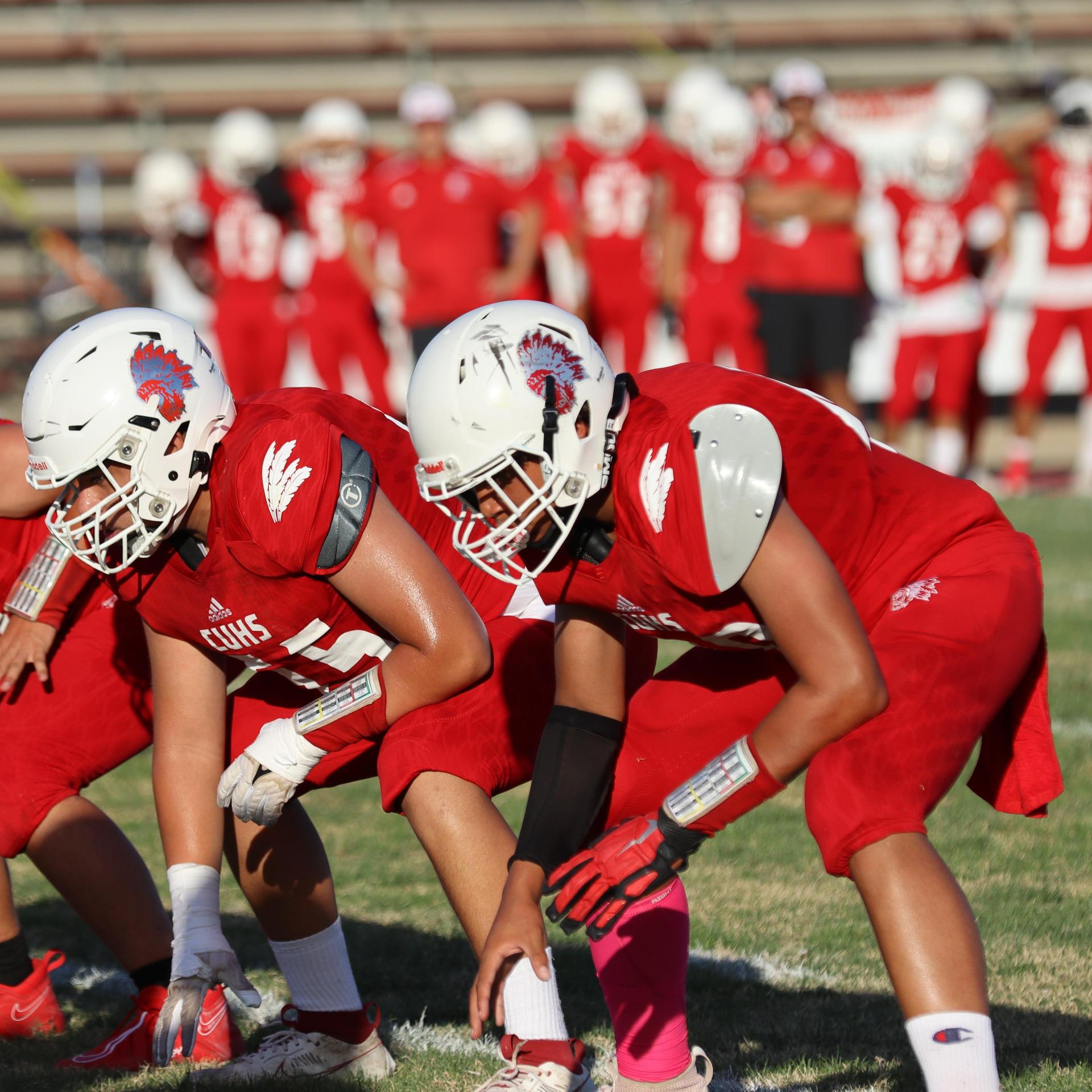 junior varsity football players in action against Fowler