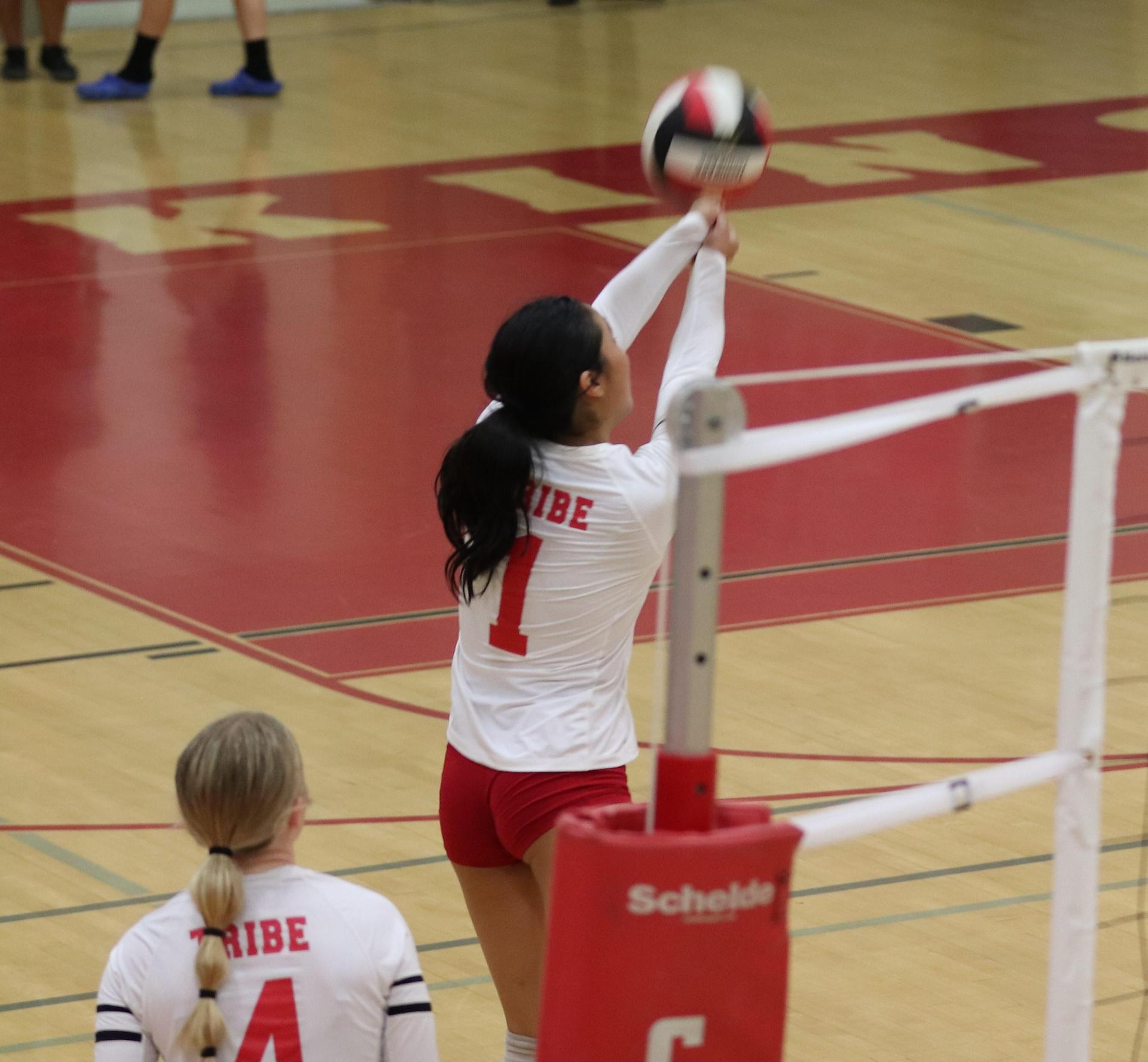 varsity volleyball players in action against Minarets