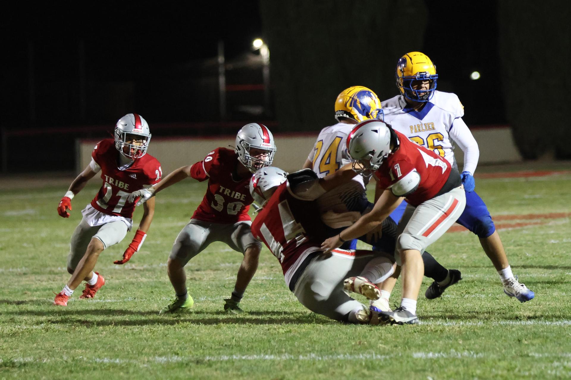 Varsity football players in action against Parlier 102