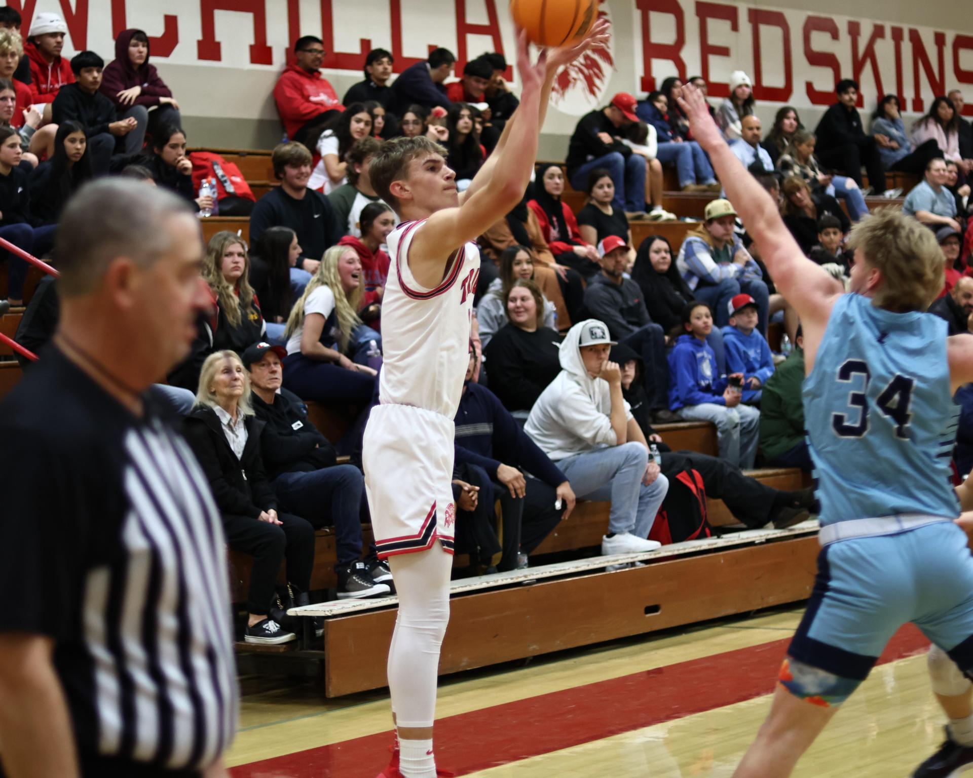 Varsity boys playing basketball against yosemite