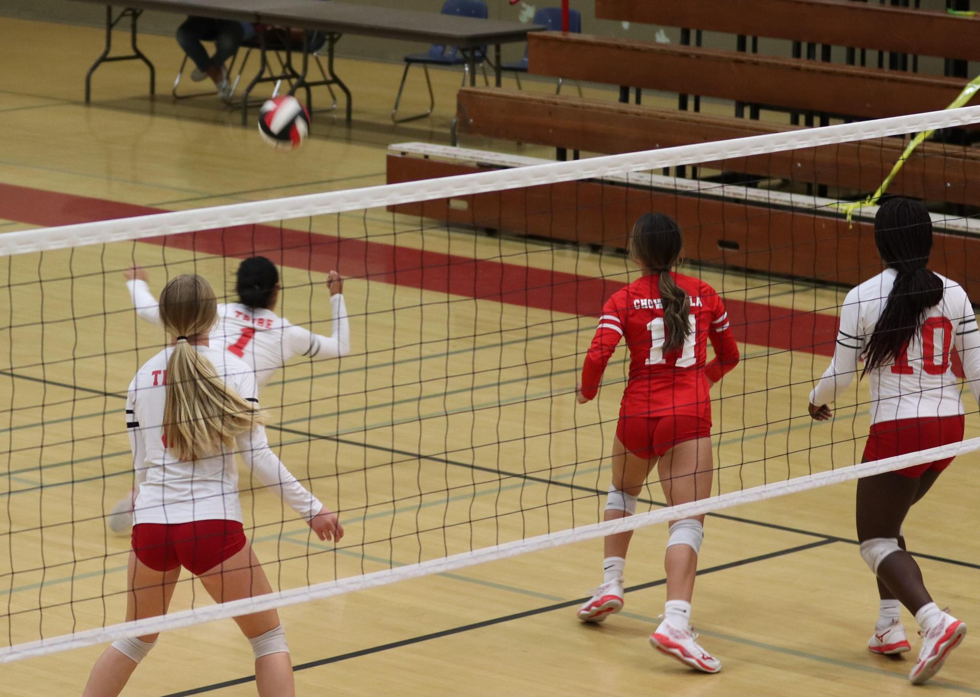 varsity volleyball players in action against Fresno Christian