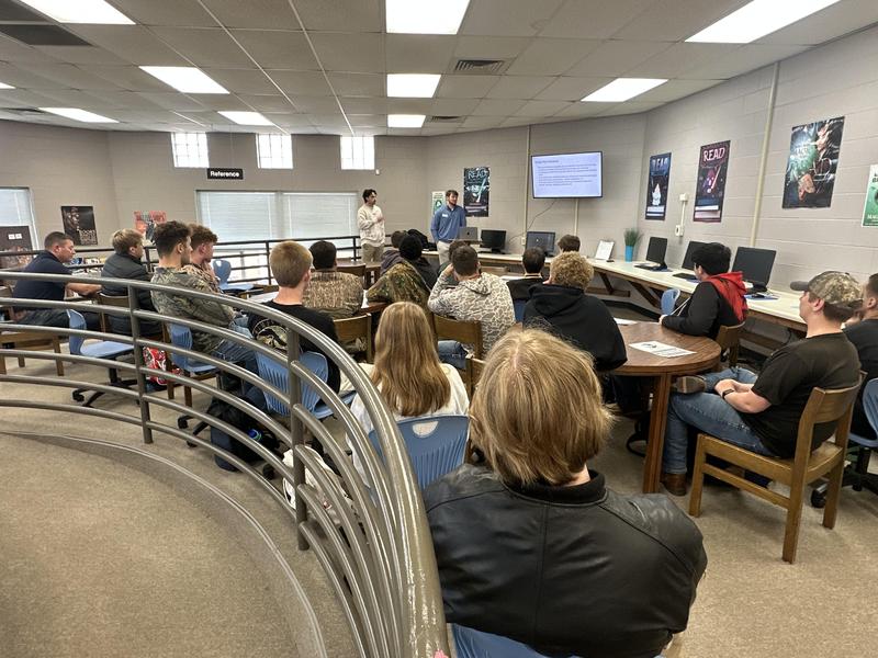 Students listening to the speakers in the library