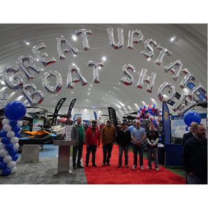 5 graduates plus instructor under balloon sign saying Great Upstate Boat Show