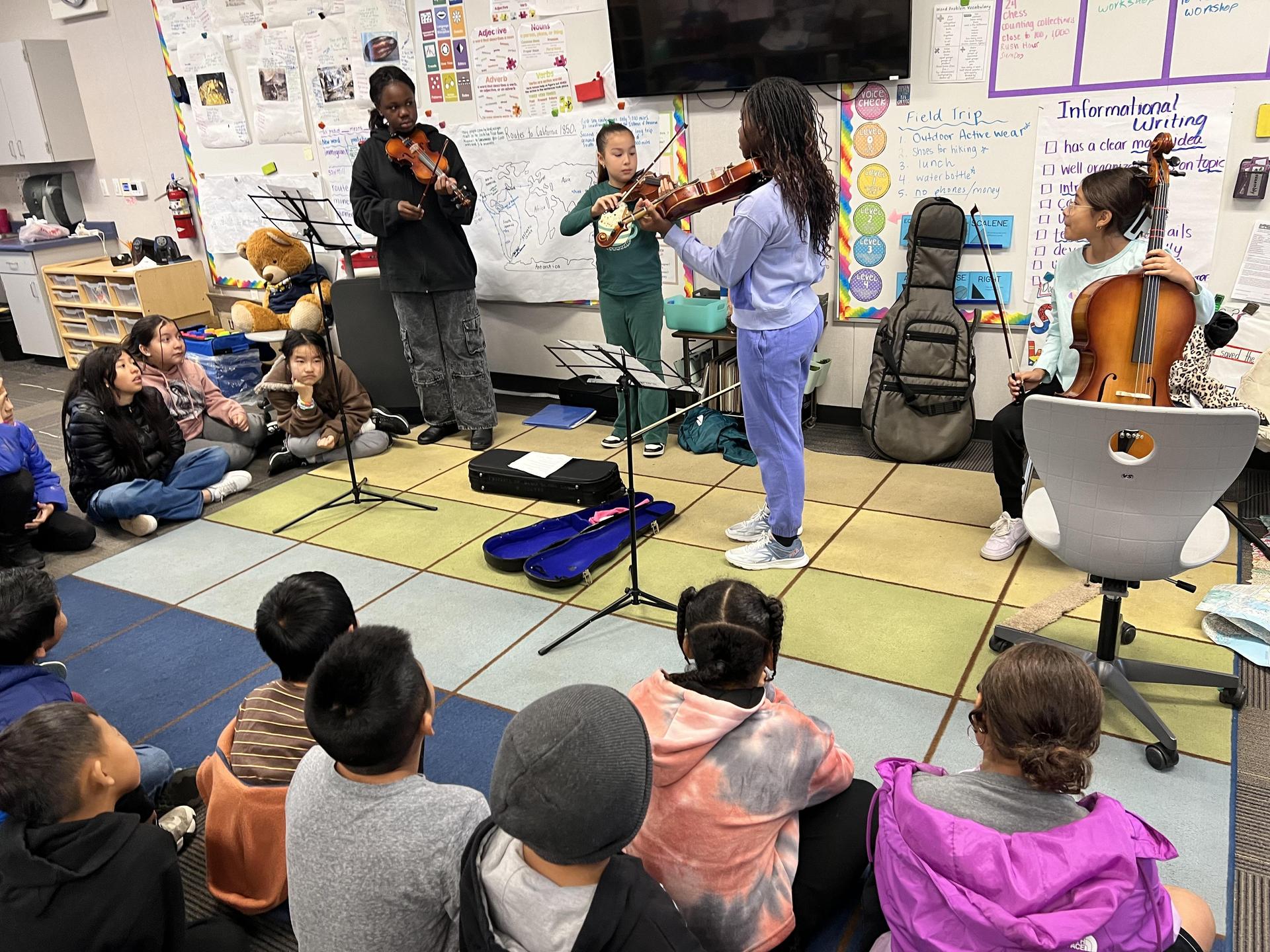 students in class playing violins