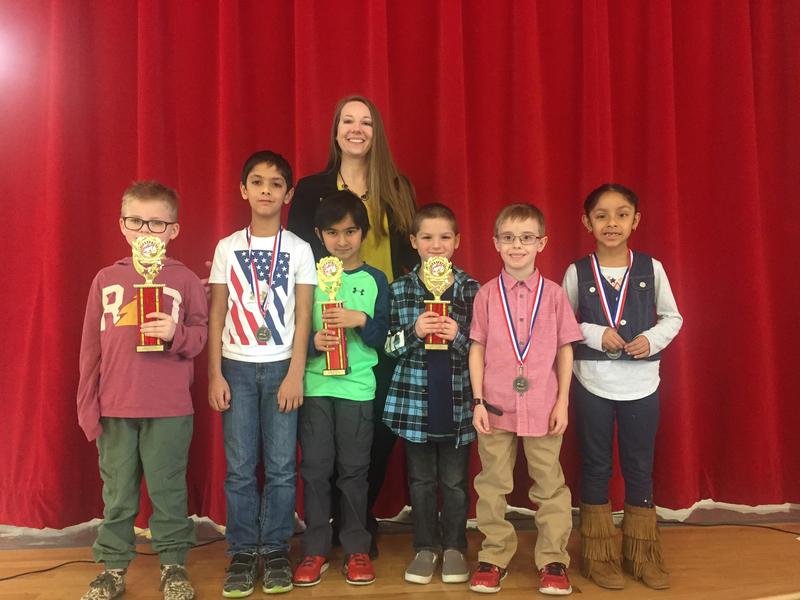 Lamar Elementary first grade spelling winners left to right holding their trophies