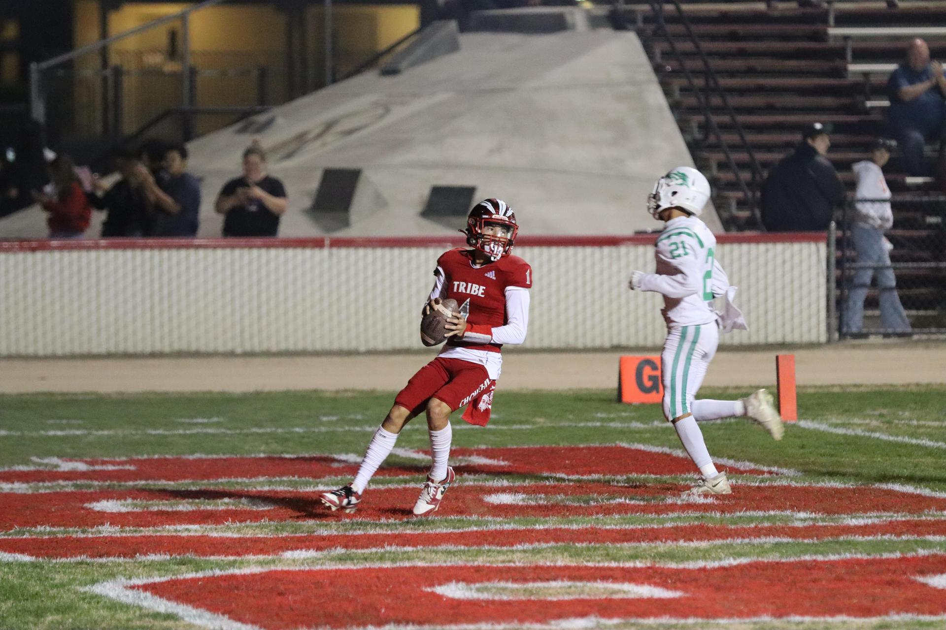 varsity football players in action against Riverdale