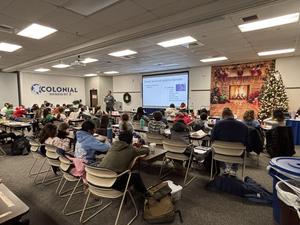 James Stout presenting to group of about 50 students who are sitting down.