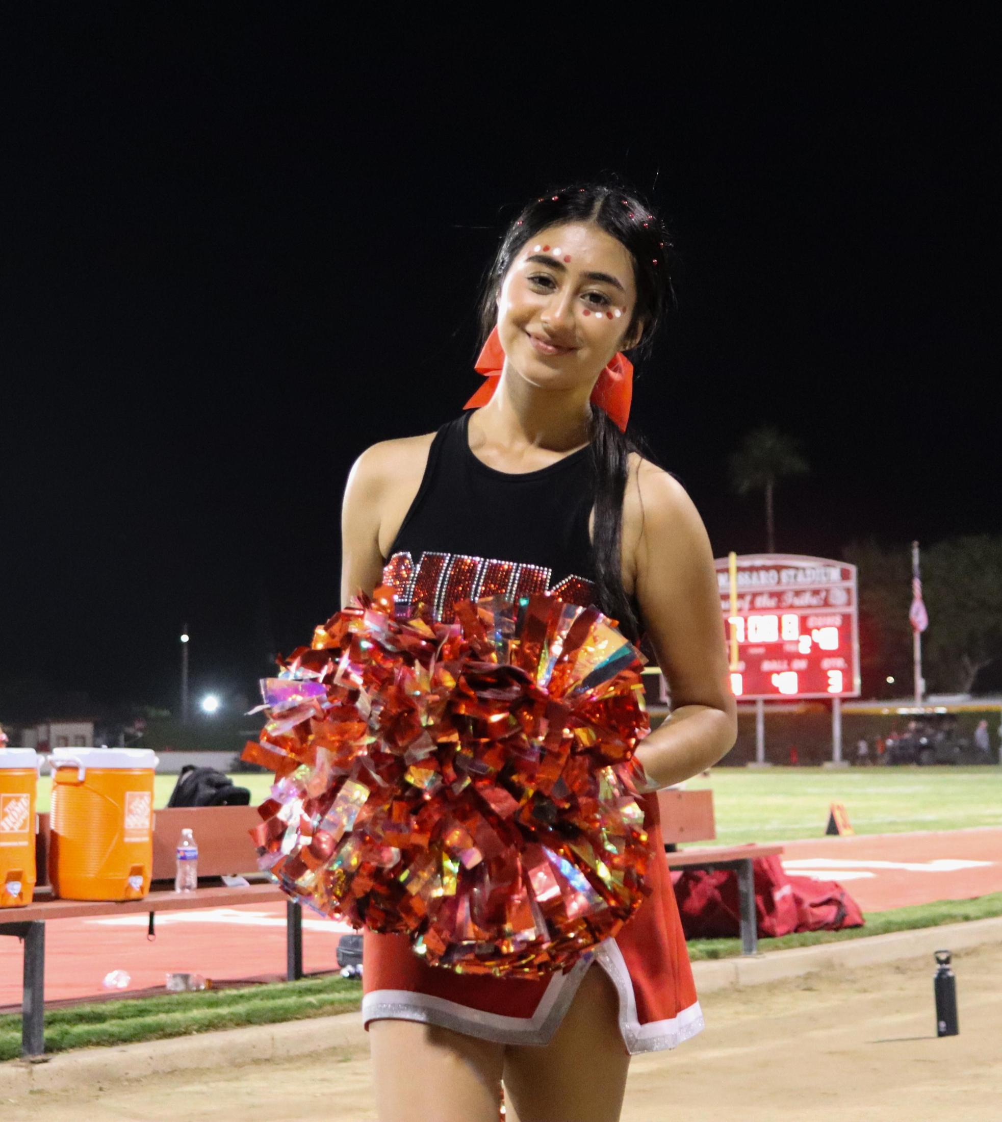 Varsity girls cheering at the Parlier football game