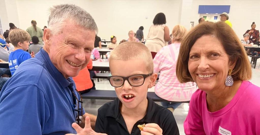 Student eating lunch with grandparents