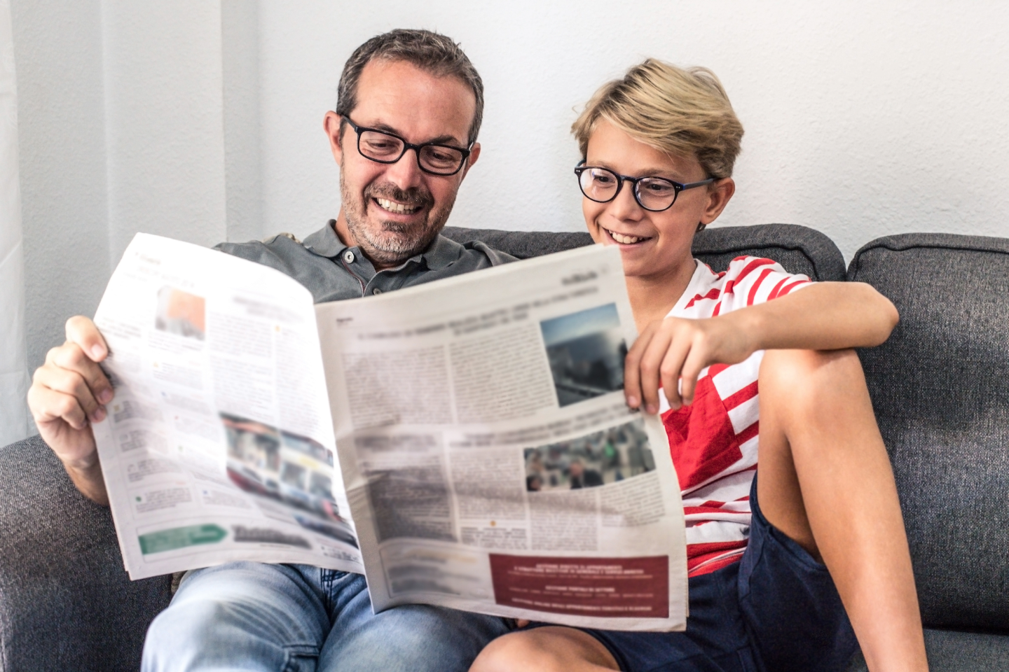 Father and son reading newspaper