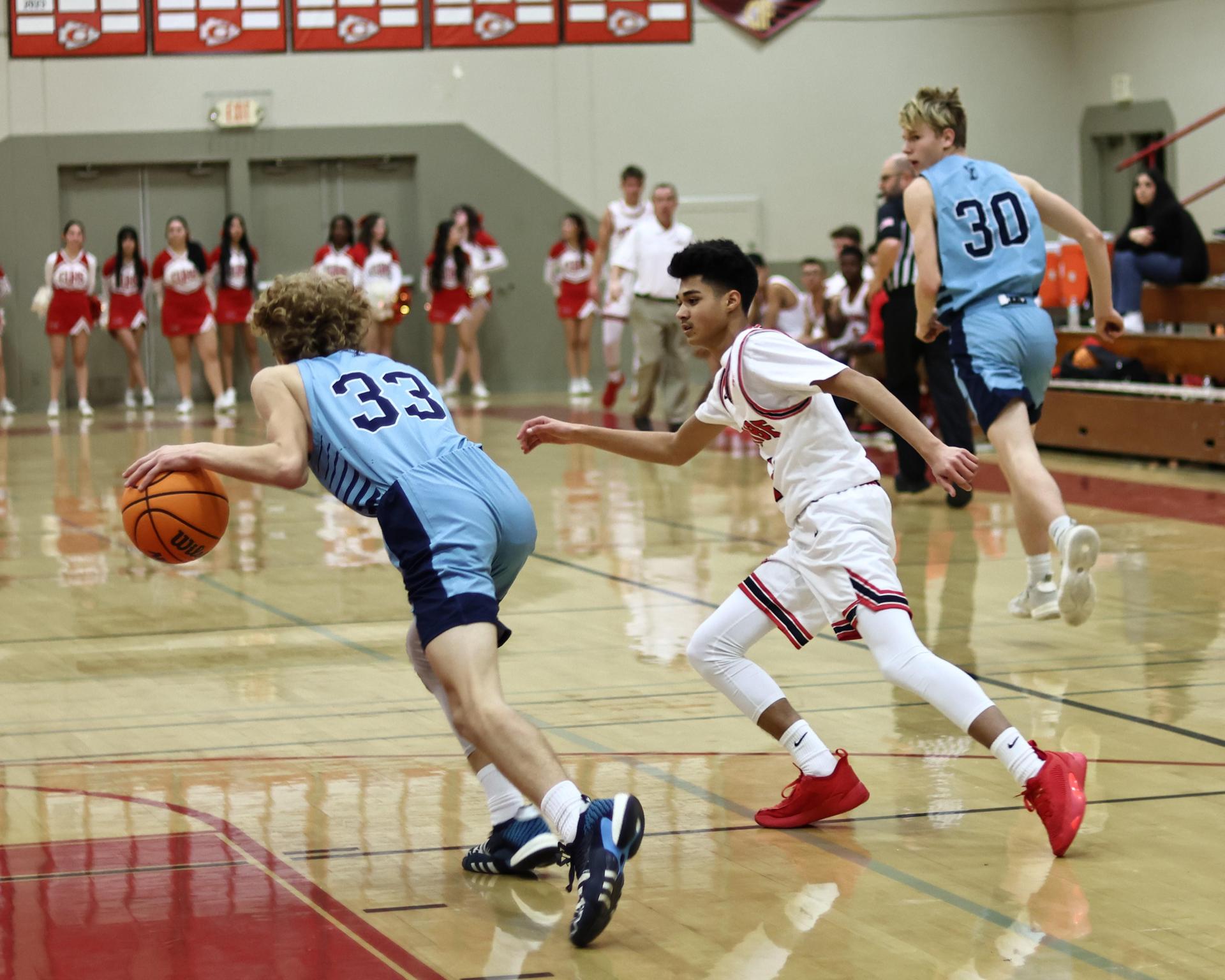 Varsity boys playing basketball against yosemite