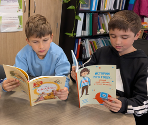 Two elementary students reading Russian literature in the classroom