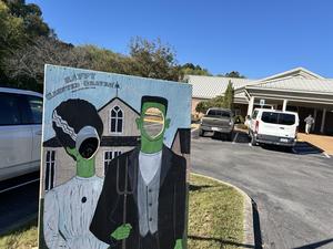 Scene board of Frankenstein and his bride outside of the public library.