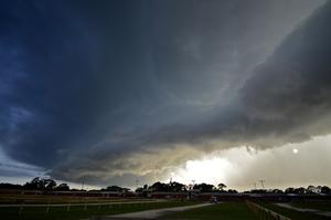 A storm cloud hovers over an area.