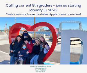 Students sitting in a heart shaped seat in front of the harbor, with text announcing increased 8th grade enrollment.