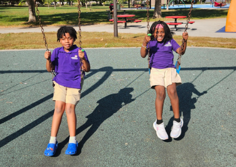 Two scholars swinging at the park