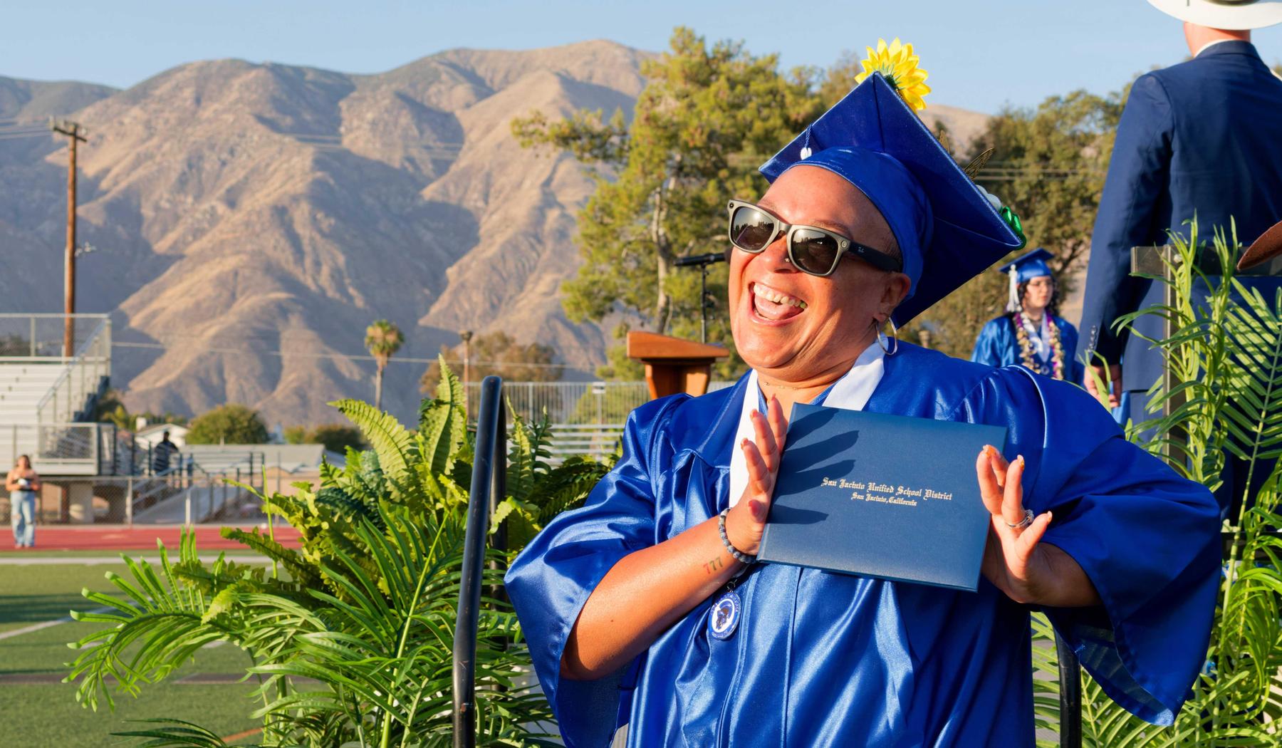 Mtn. View graduate showing diploma