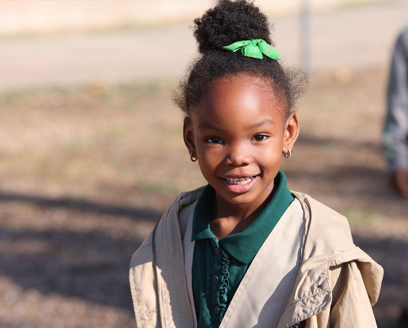 Smiling children together outdoors.