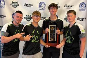 Coach John Carlisle, Colton Payne, Johnny Lovas, and Kristian Grills display their state championship plaque