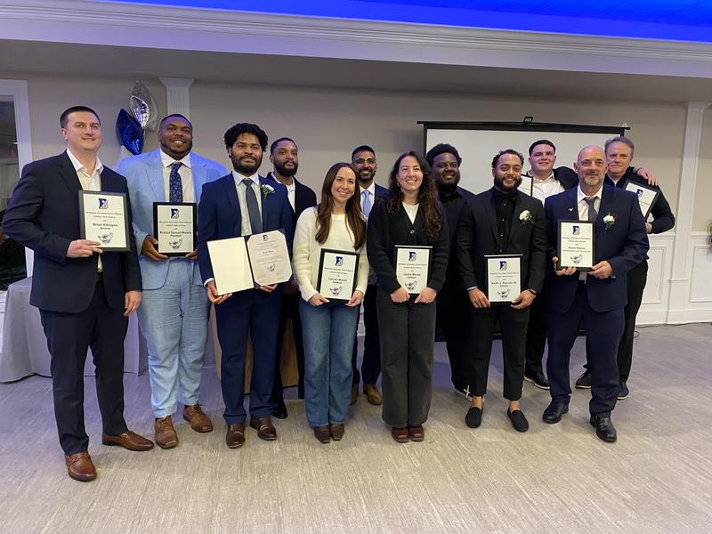 Image of 12 men and women holding their hall of fame certificate