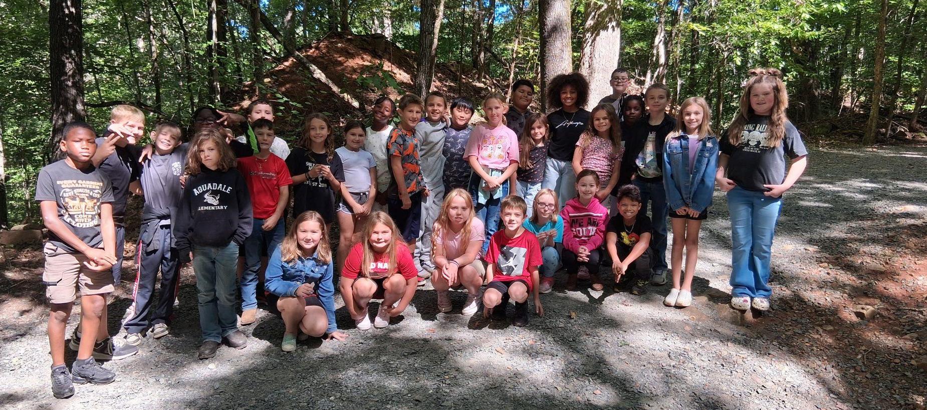 Group of students standing in front of trees