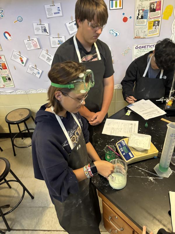students with container, measuring