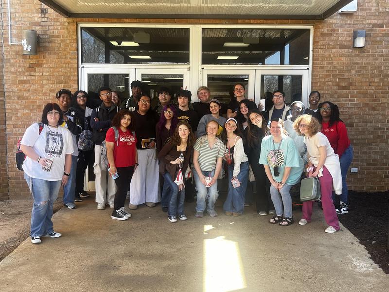Group picture of theater class at the entrance of the ICC performing arts building