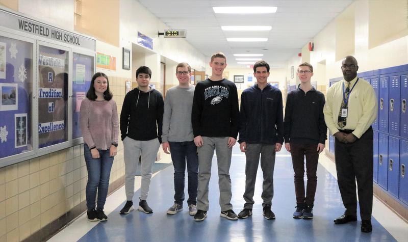 Six Westfield High School students recently achieved the highest score possible on portions of SAT and ACT standardized tests. The 6 perfect scorers are pictured here with WHS principal Dr. Derrick Nelson.