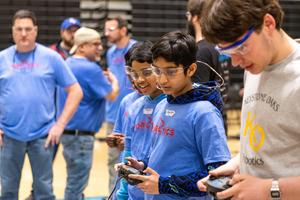 Teams look on during the competition
