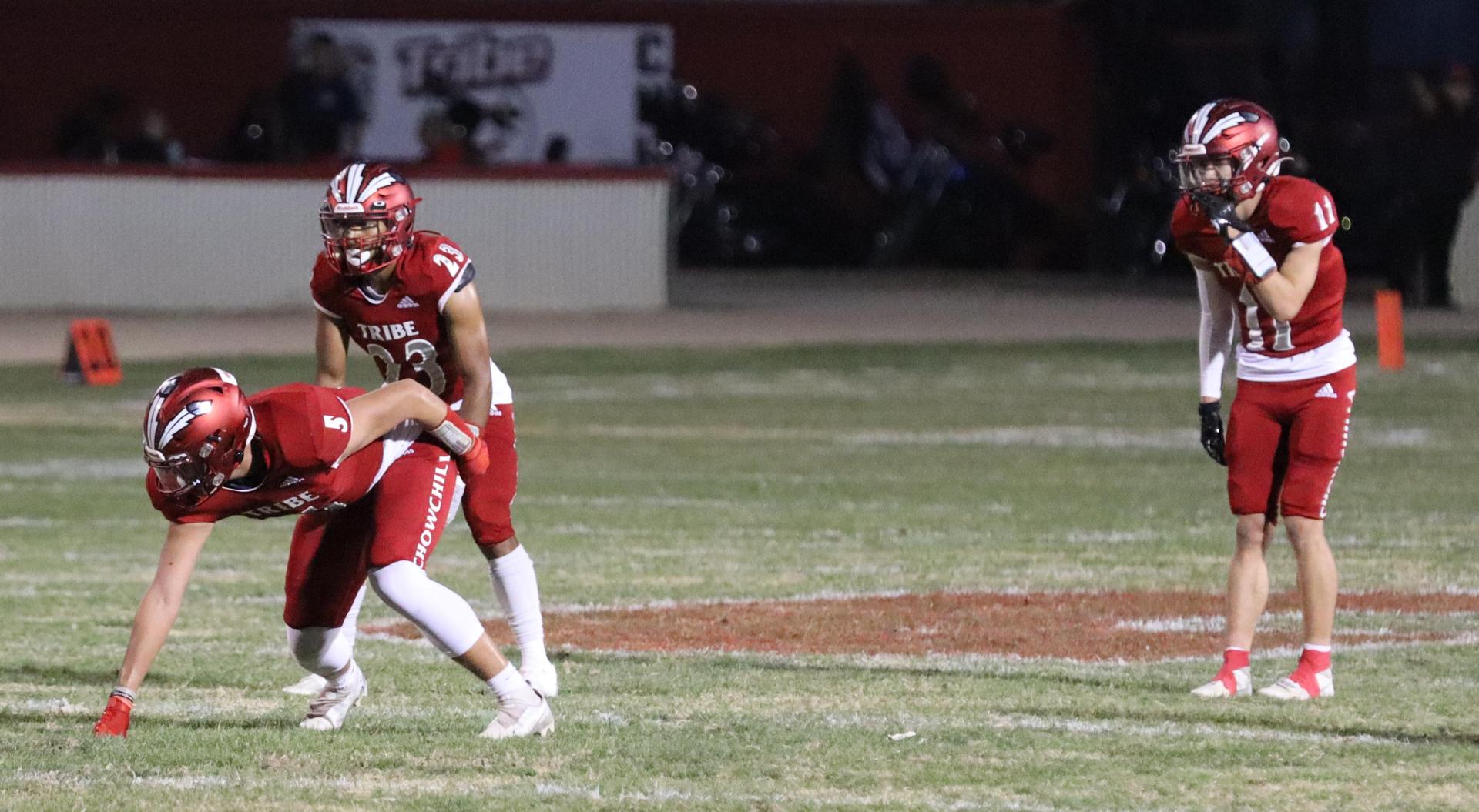 varsity football players in action against Riverdale
