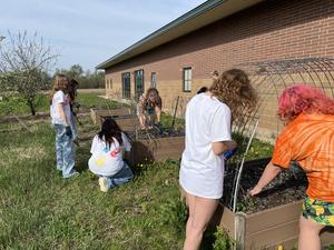 Students help prep the middle school garden.