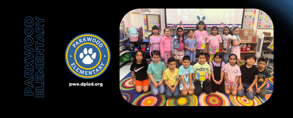 Group of students posing together in a colorful classroom setting.