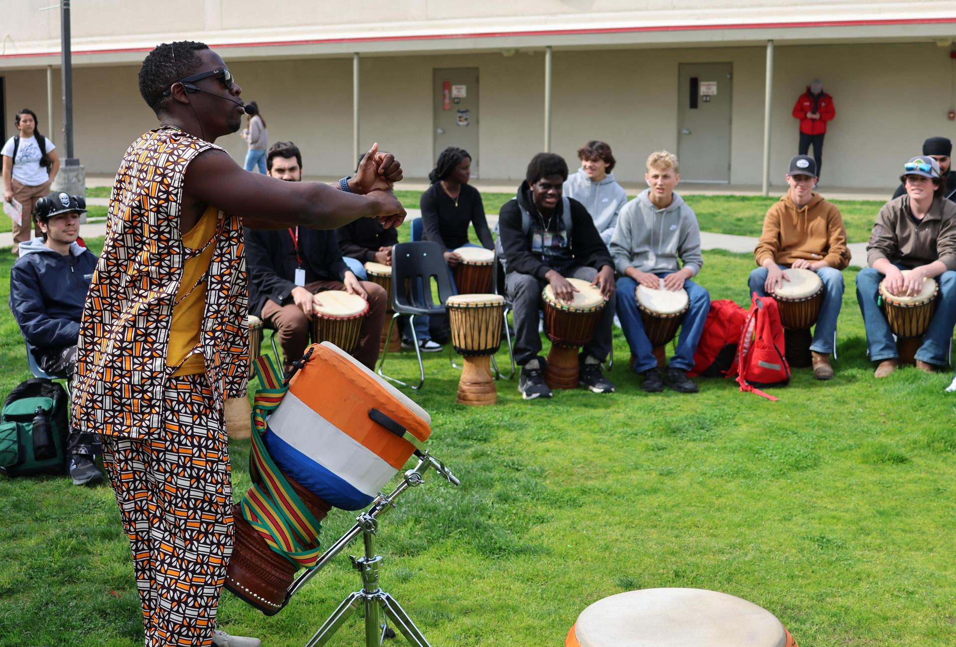 students and staff participating with the African Drum Interactive