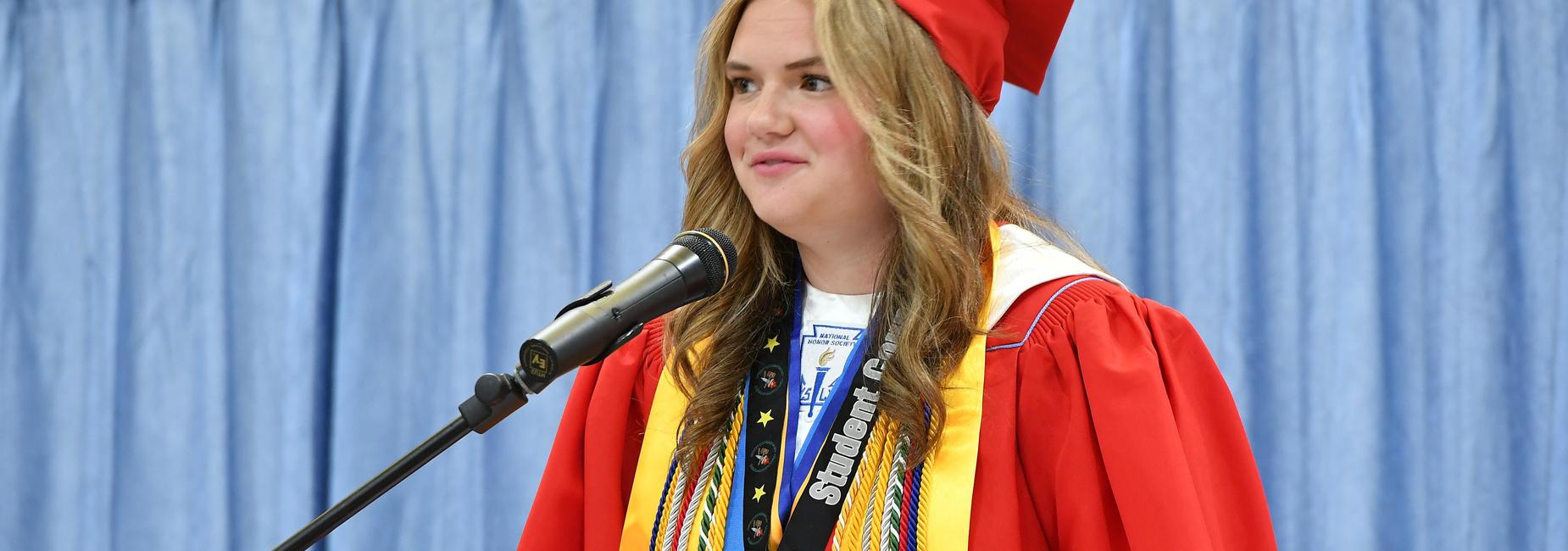 Student giving speech at graduation.