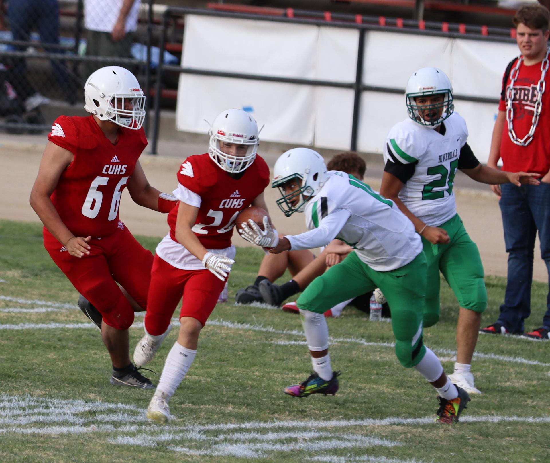 junior varsity football players in action against riverdale