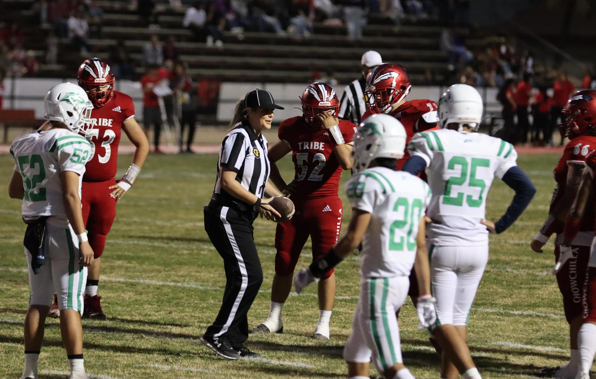 varsity football players in action against Riverdale