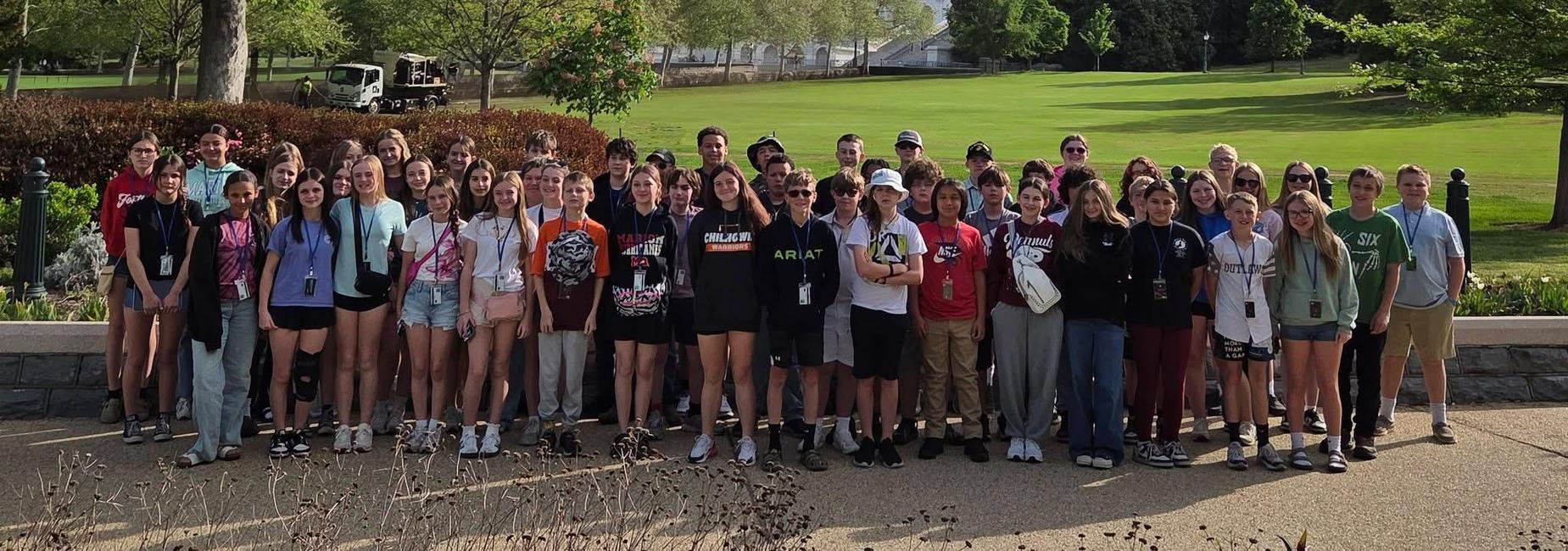 three rows of students standing in front of the Capital building in Washington DC during a 7th grade field trip