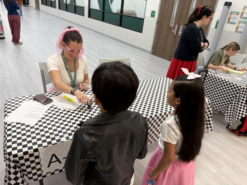 Children registering at a table.