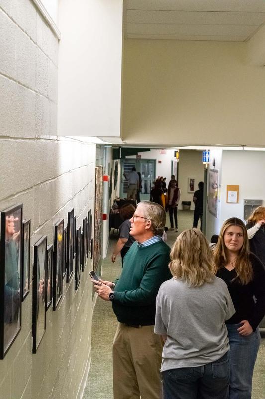 Crowd enjoying artwork on the gallery walls