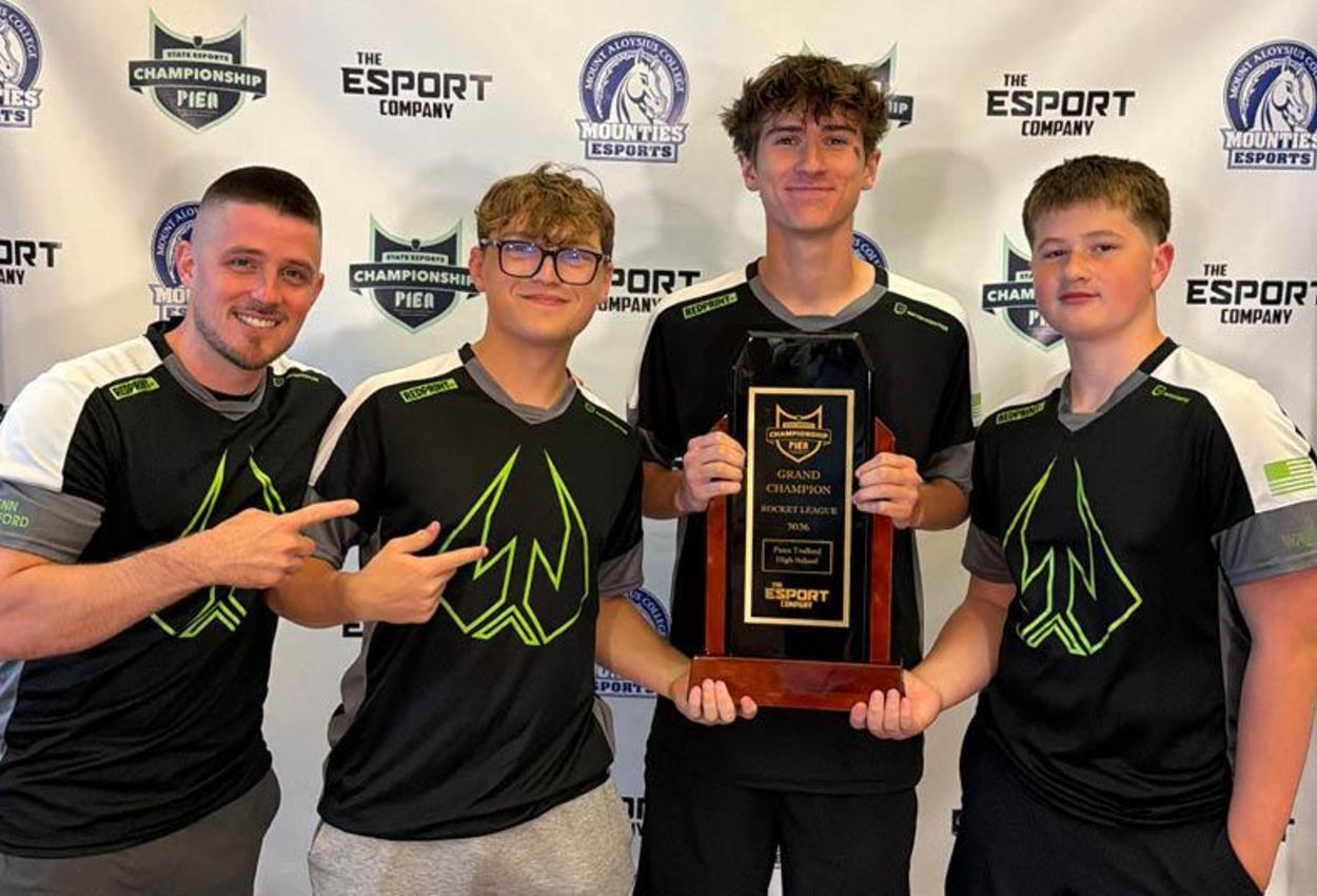 Penn-Trafford High School ESports Coach John Carlisle, with his players Colton Payne, Johnny Lovas, and Kristian Grills display their state championship plaque