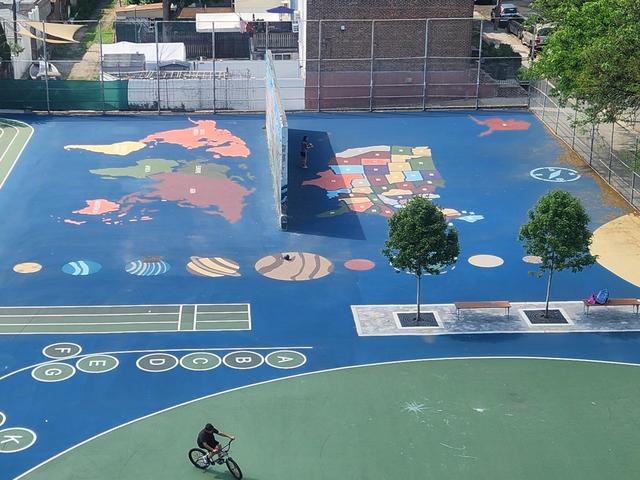 Colorful playground mural depicting a world map and game elements.
