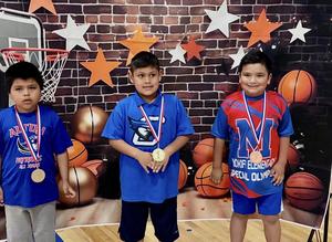 3 Special Olympics students with metals