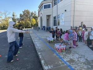 Students throw water balloons at principals.