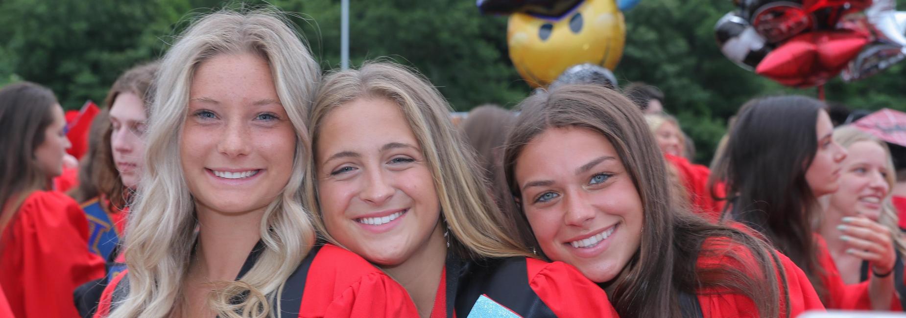 3 female graduates smiling